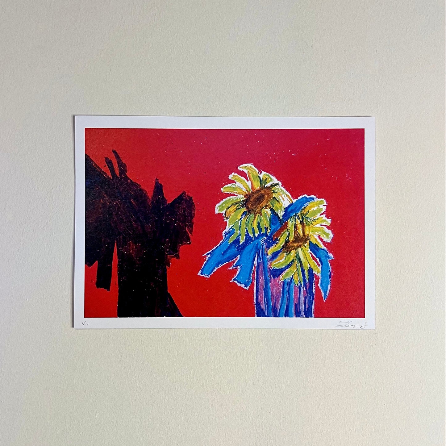 Artwork of a black silhouette and two colorful sunflowers on a red background.